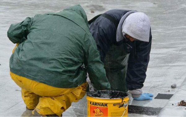 Emergency roof leak repair team at work repairing a roof in the San Francisco Bay Area