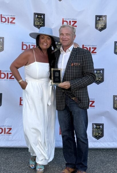 Gary and Shena Harvey Celebrate Wedge Roofing's Gold Medal Award.